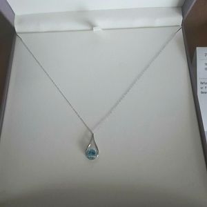 Blue topaz and diamond drop pendant. 10k white gold.